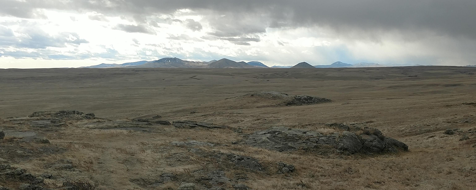 Fort Belknap: View of the Little Rockies from Snake Butte A landscape with dry prairie in the foreground and a mountain range in the distance