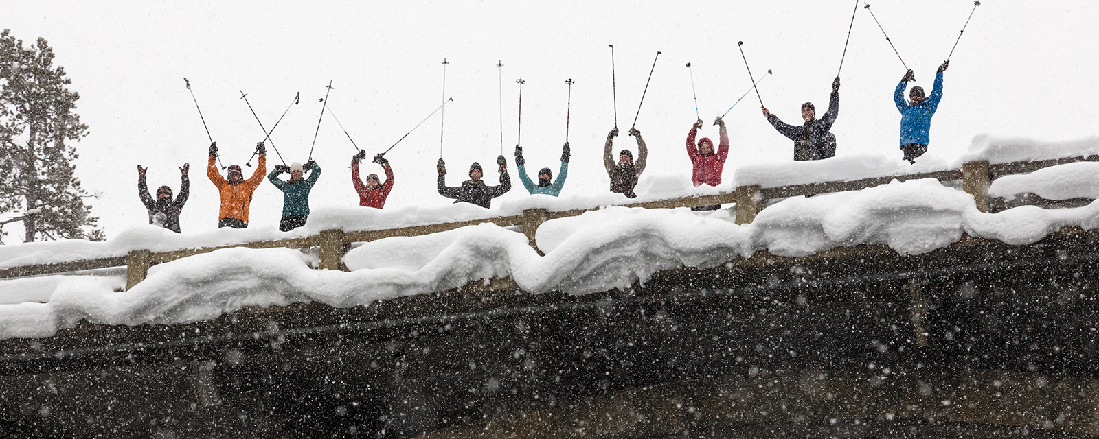 Cross-Country Skiers at Yellowstone National Park Cross-country skiers raise their ski poles on a bridge