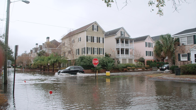 Water in the streets during a high-tide event on a sunny day in Charleston, South Carolina
